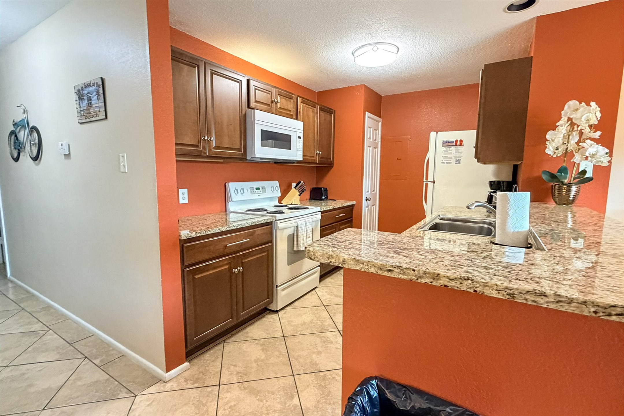 Well-appointed modern kitchen with beautiful granite countertops and generous space for cooking and entertaining