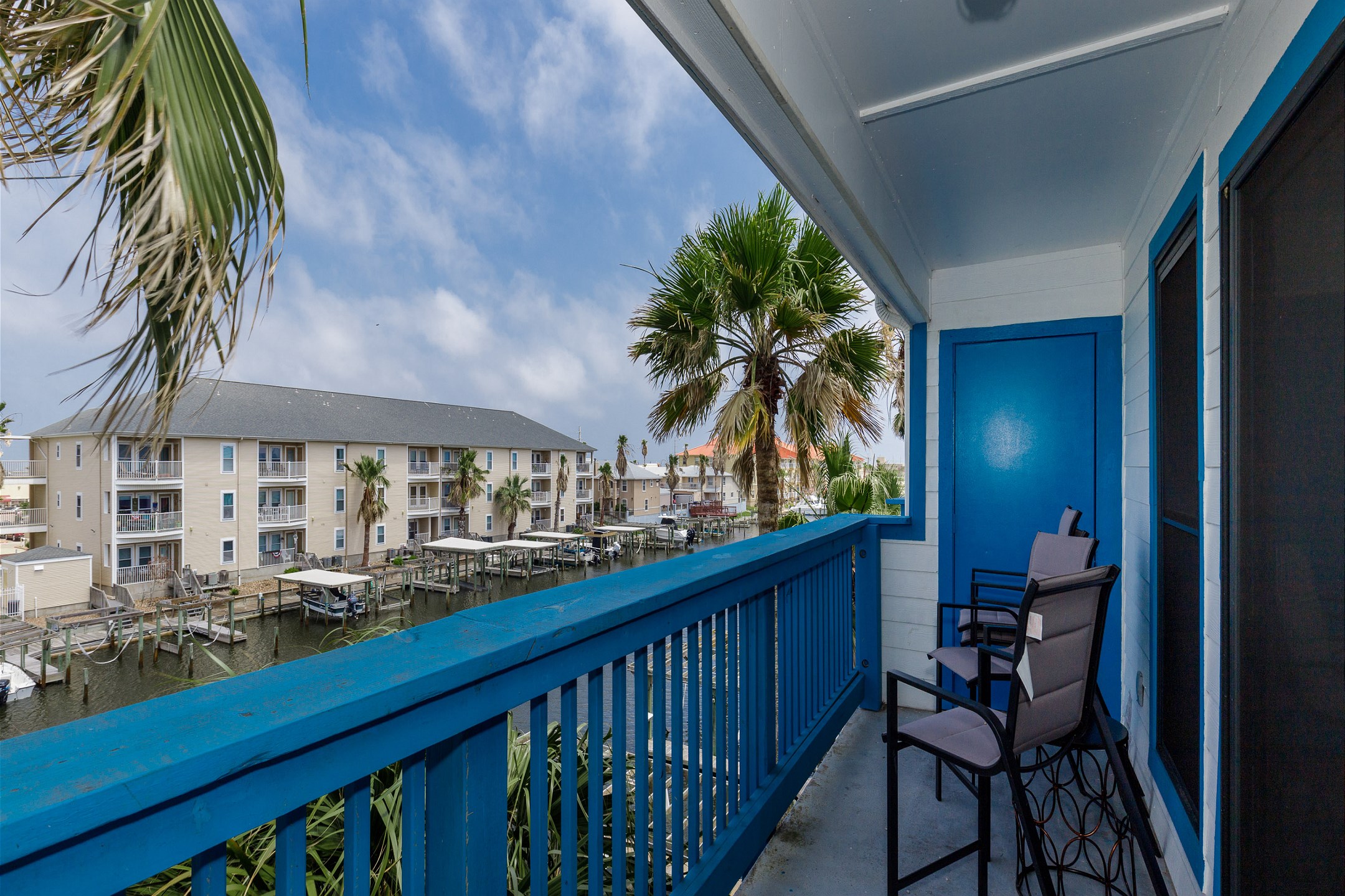 An inviting balcony featuring seating area and stunning waterfront views