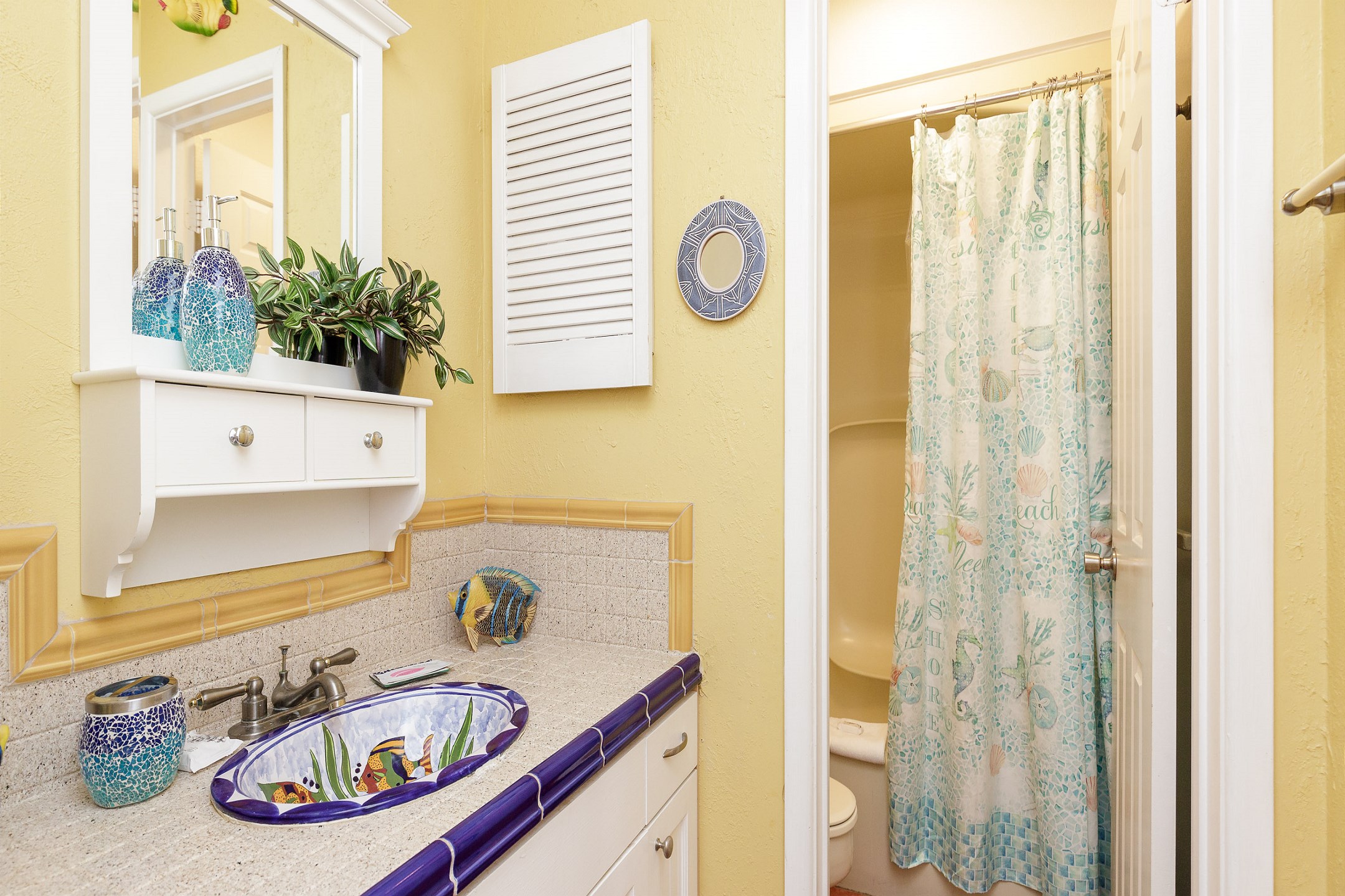 Guest bathroom with separate sink area and tub/shower combo