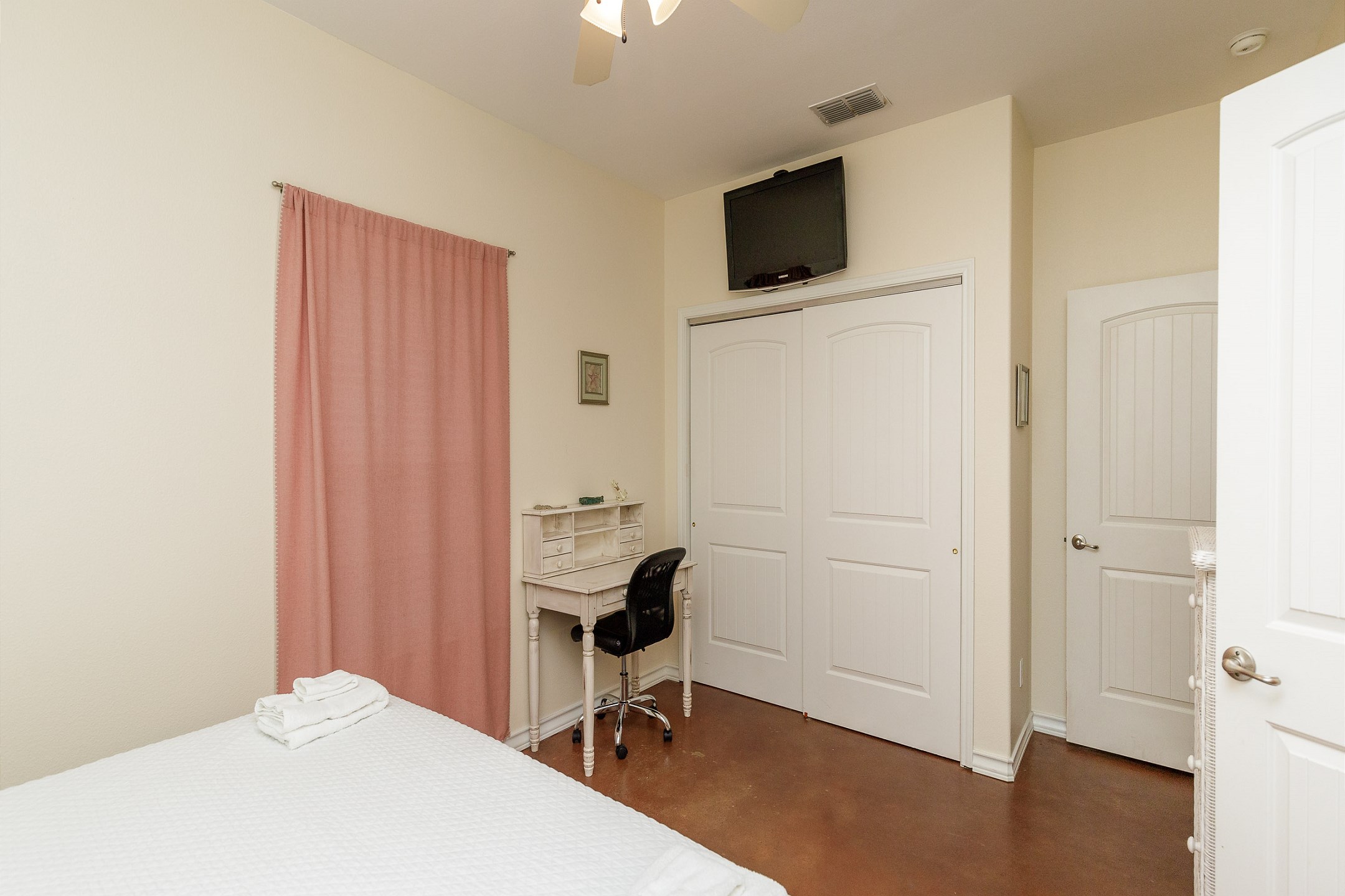 Master bedroom with king size bed, desk, ensuite bathroom, and TV