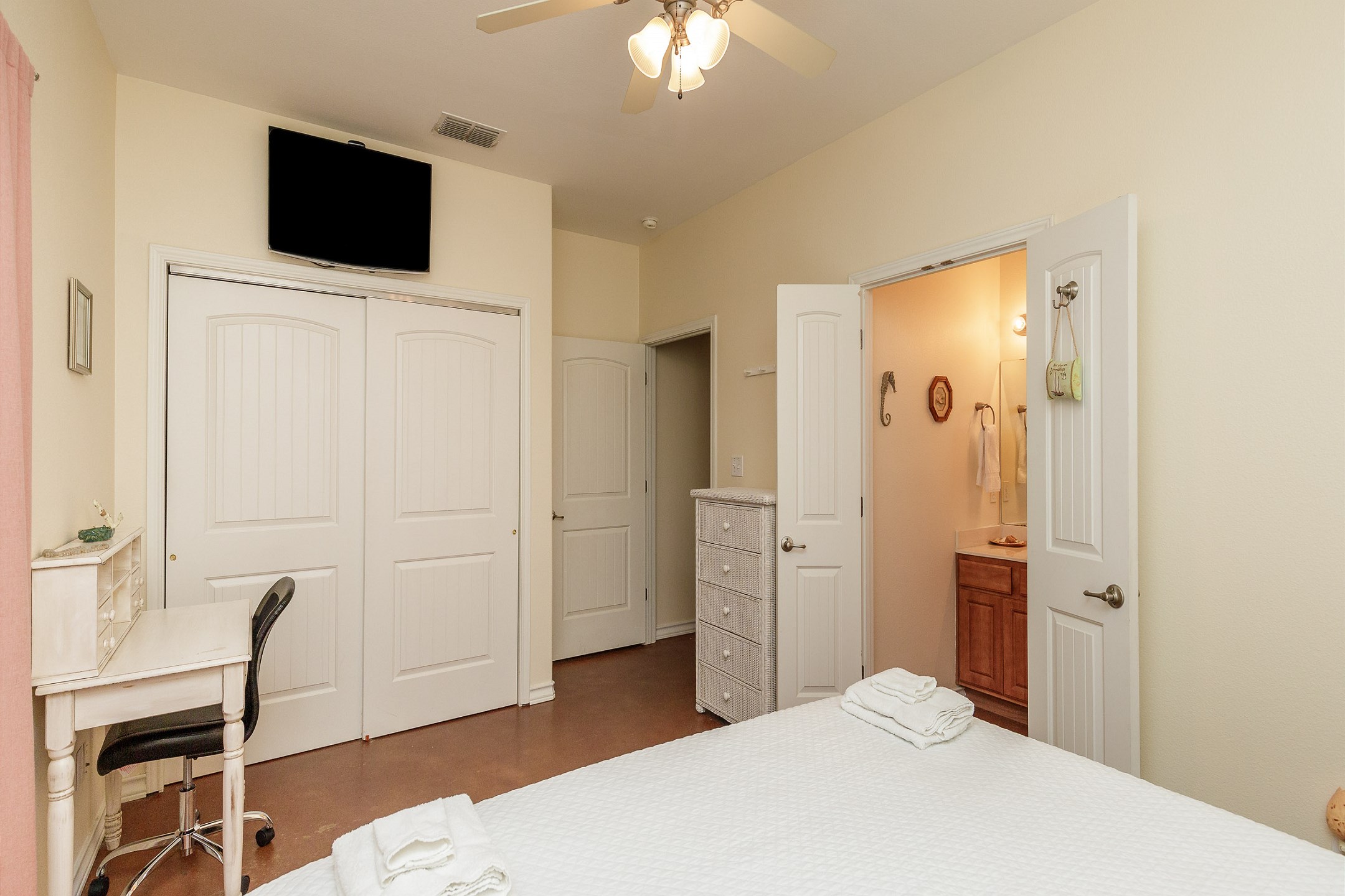 Master bedroom with king size bed, desk, ensuite bathroom, and TV