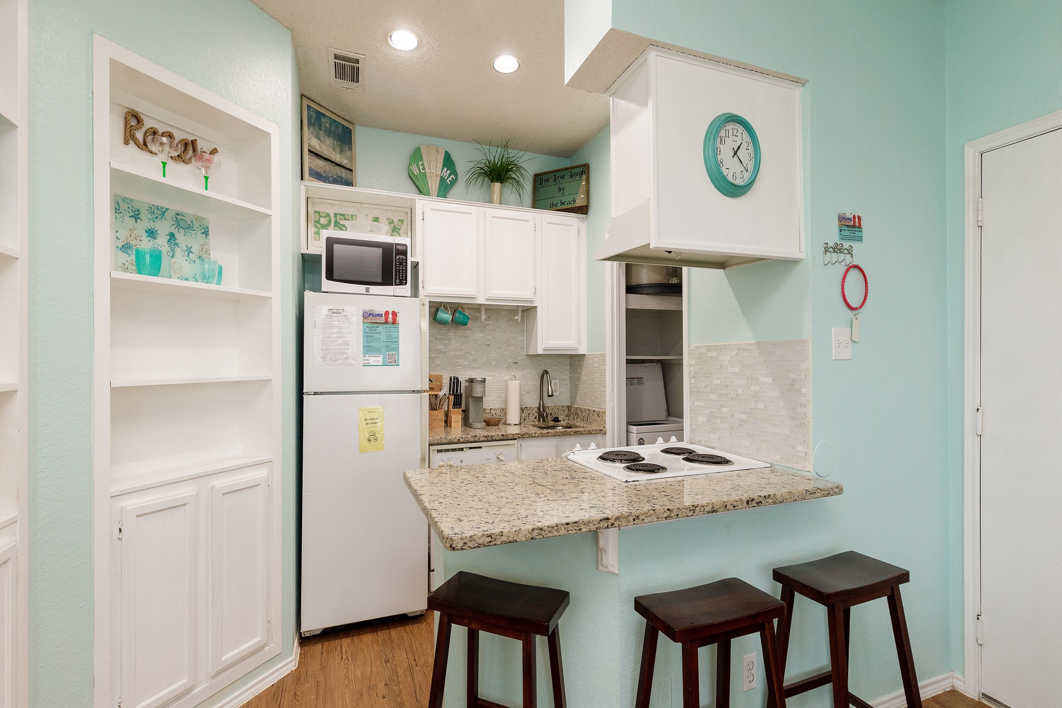Fully equipped kitchen area with breakfast bar