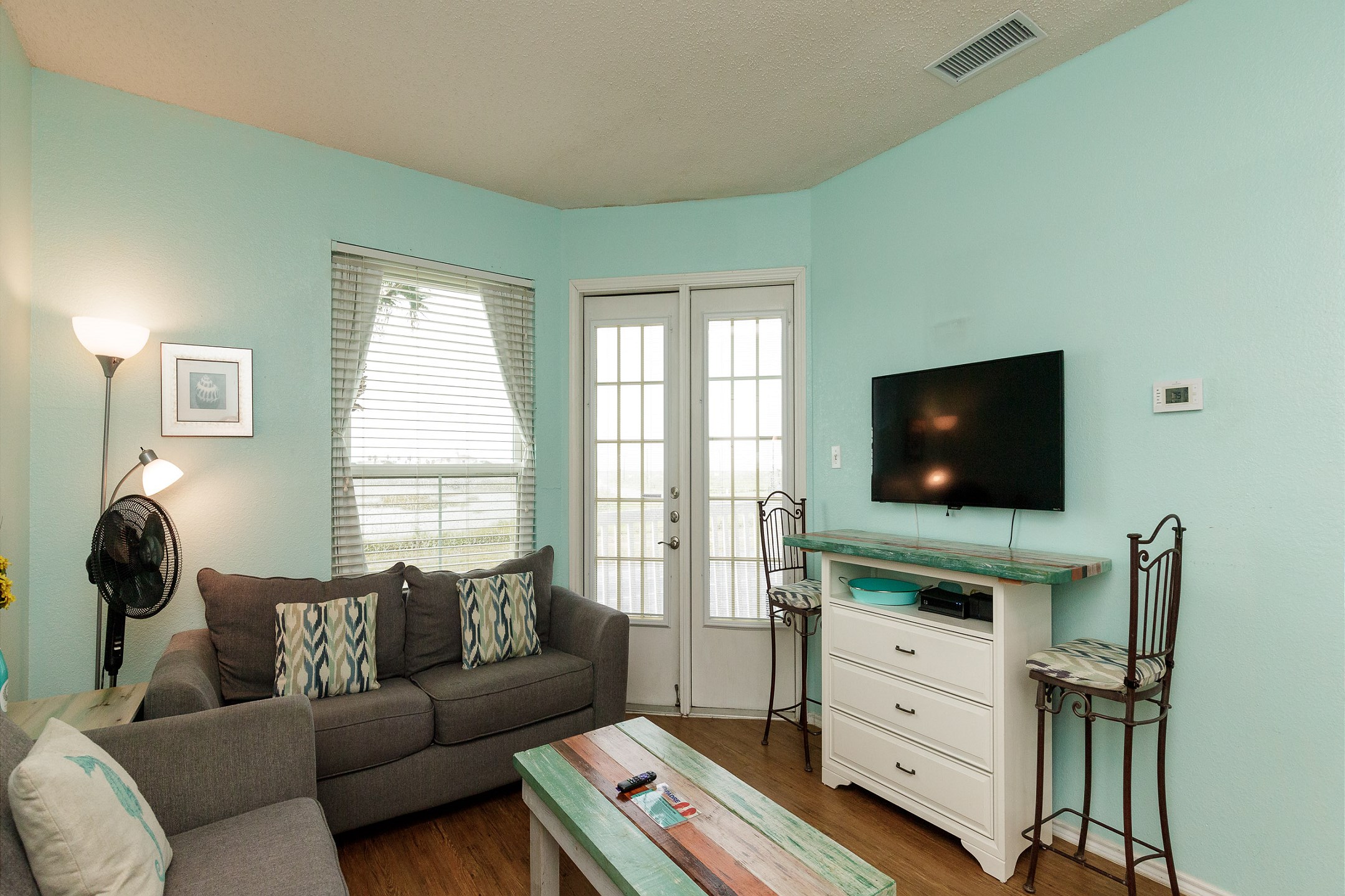 Living area with flat screen TV and private balcony 