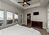 Master bedroom on the third floor with king size bed, private balcony, private bathroom, and two walk in closets 
