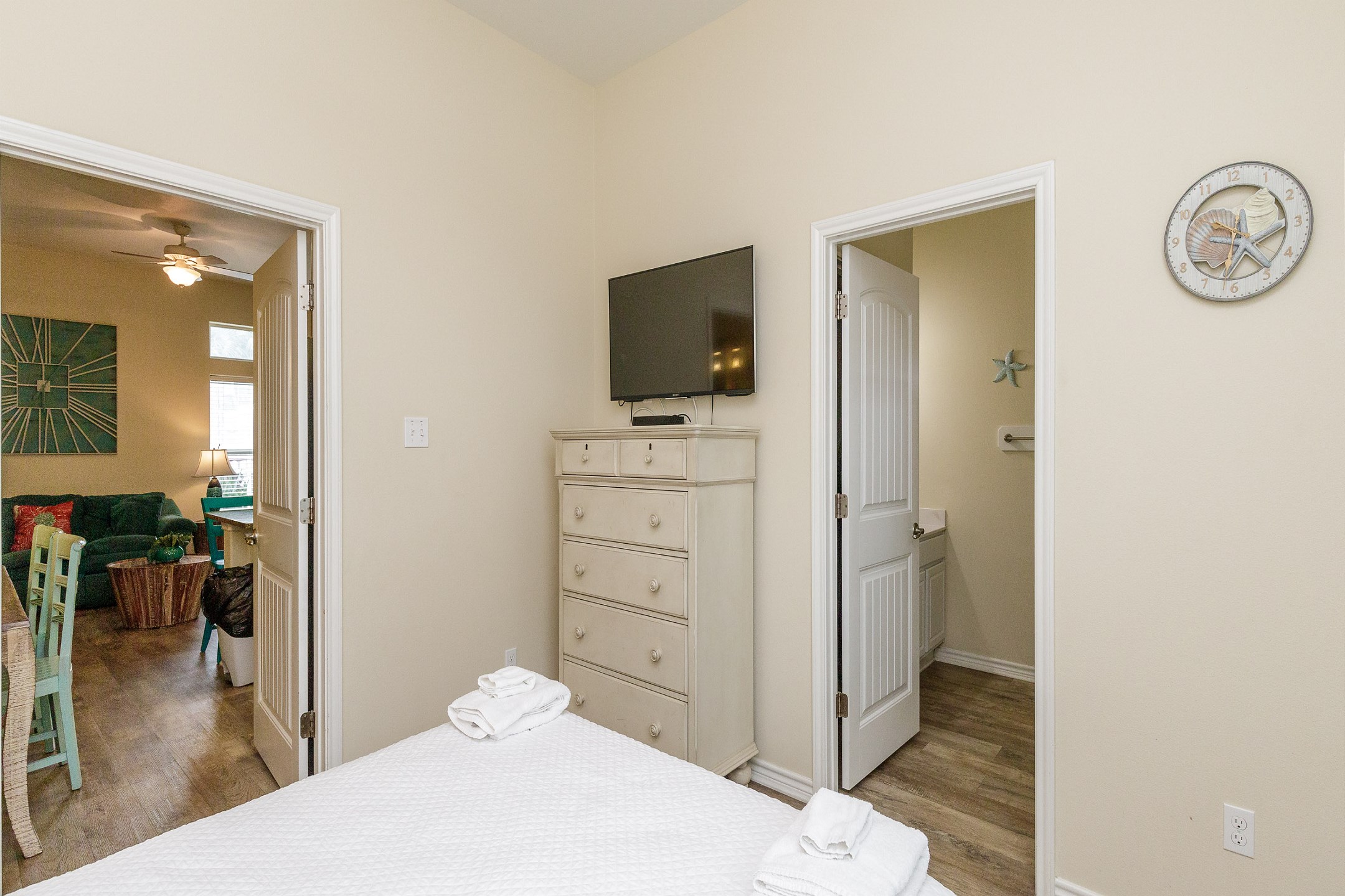 Master bedroom on the first floor with queen size bed, private bathroom, access to the patio, and flat screen TV