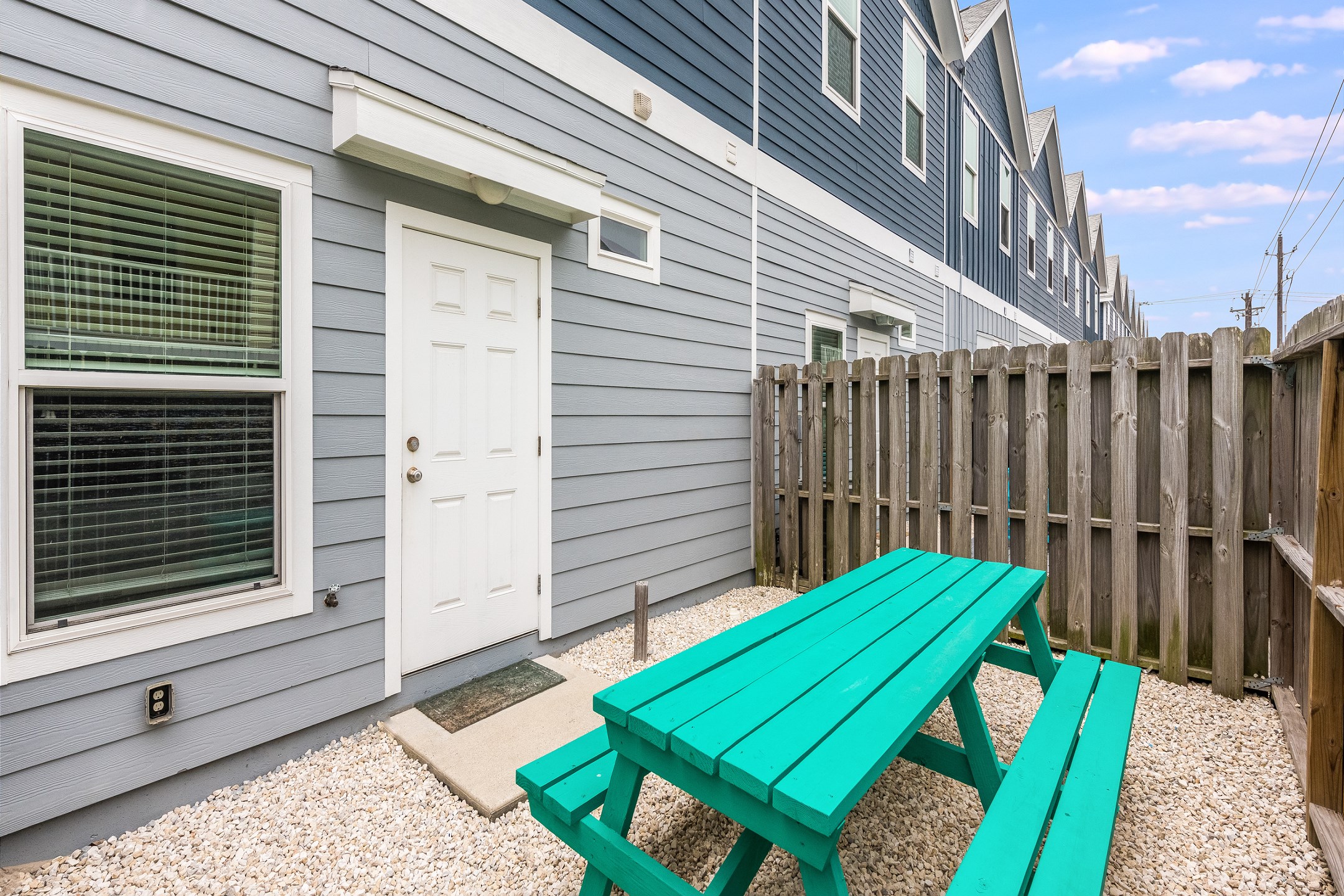 Private, fenced in patio off the master bedroom with picnic table and chairs 