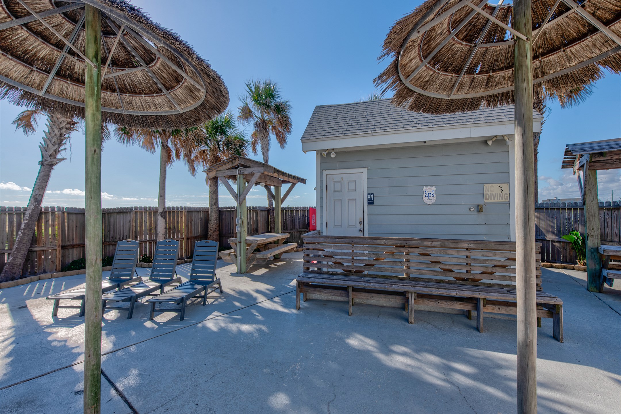Plenty of seating for the whole family with picnic tables, loungers with tall palapas for shade