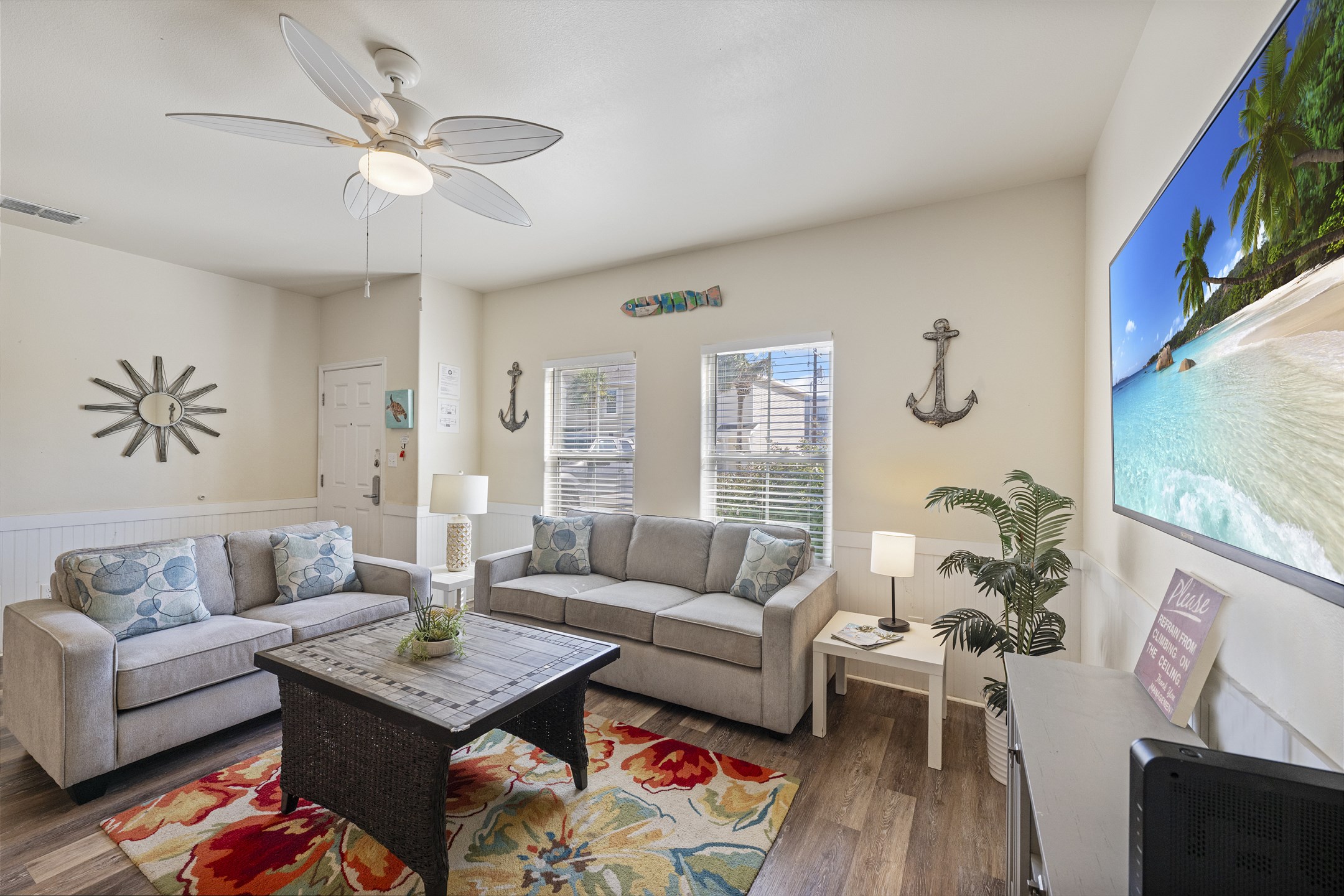 Relax in a spacious, coastal-inspired living room with plush seating and natural light