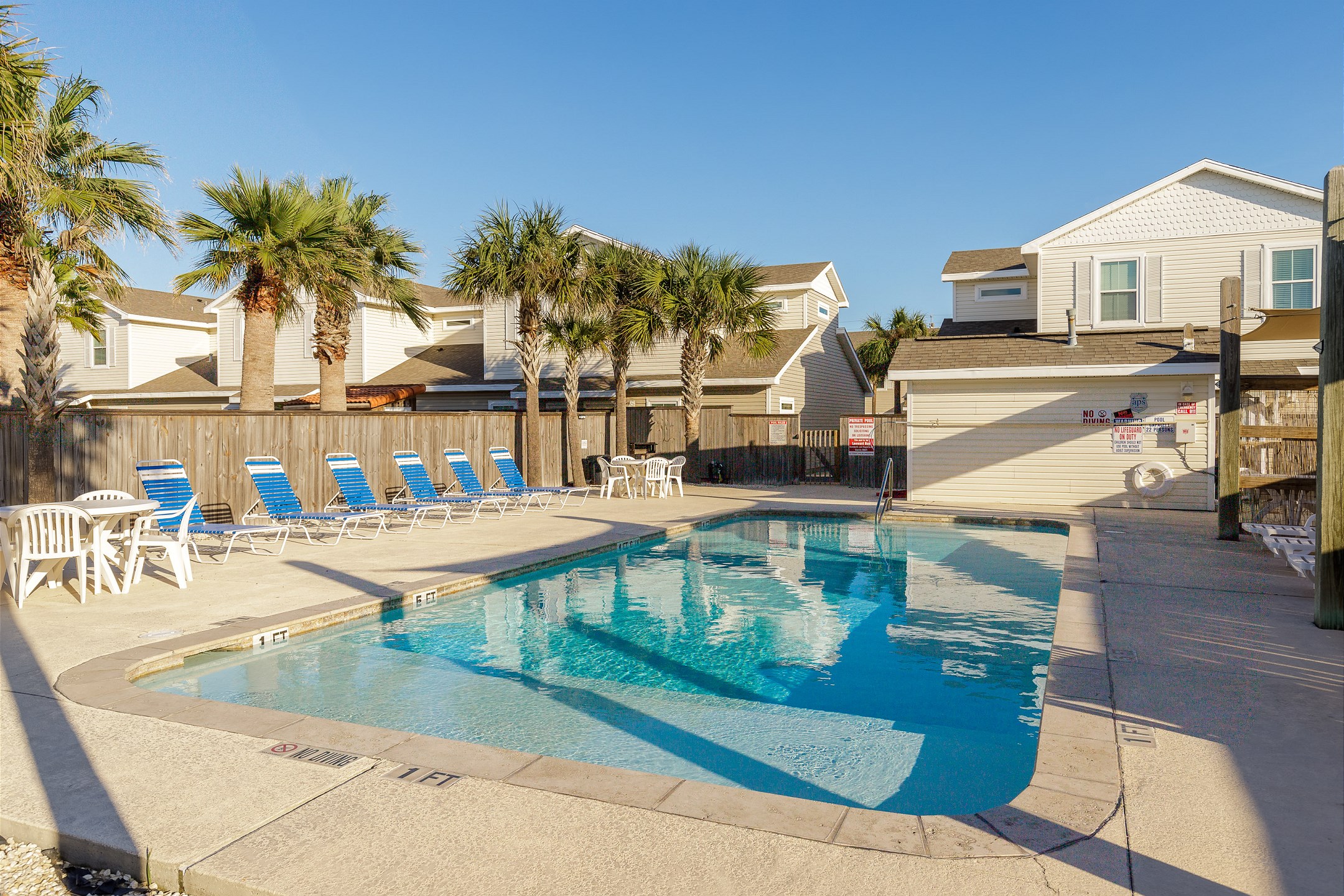 Sparkling pool with plenty of comfortable loungers and chairs