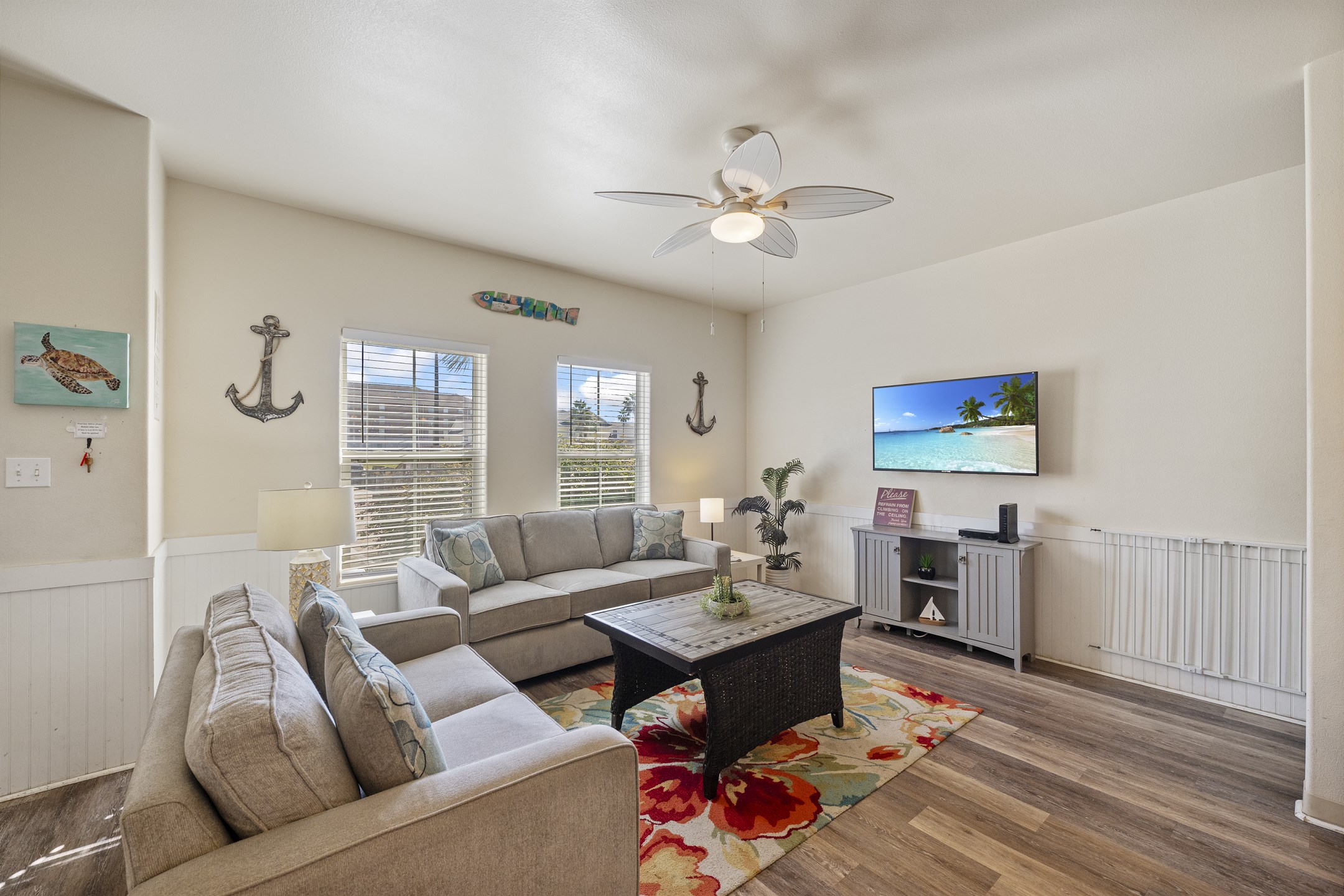 Cozy lounge space with large windows, ideal for unwinding after a beach day