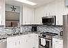 Fully equipped kitchen with stainless steel appliances and ample storage space