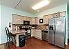 Open kitchen area with ample storage and breakfast bar for two 