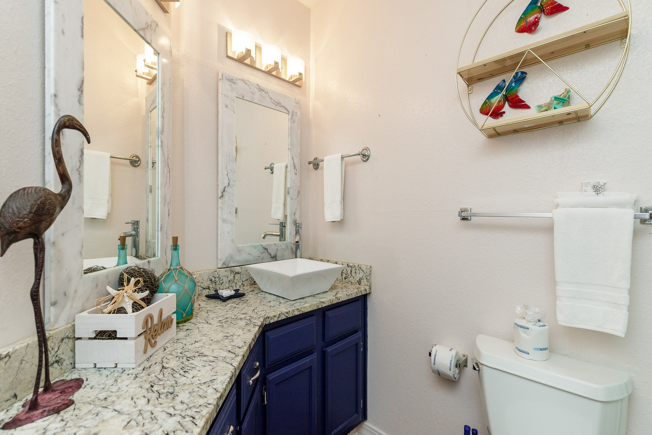 Updated bathroom with granite counter top and ample storage