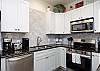Fully equipped kitchen with stainless steel appliances and ample storage space