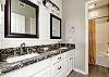 Master bathroom with double sinks and ample storage space 