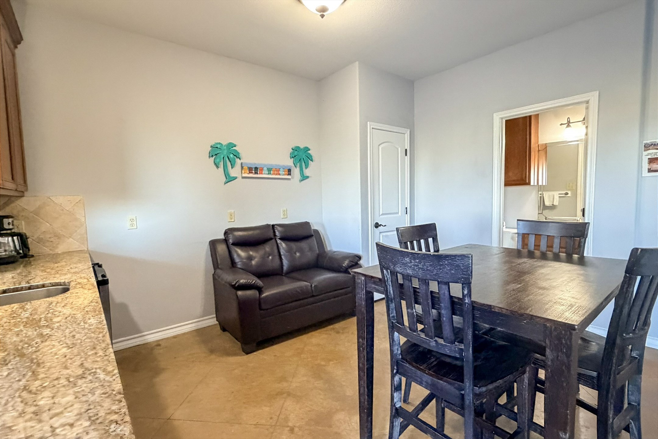 Mother-in-law suite dining space with seating for four and cozy loveseat 