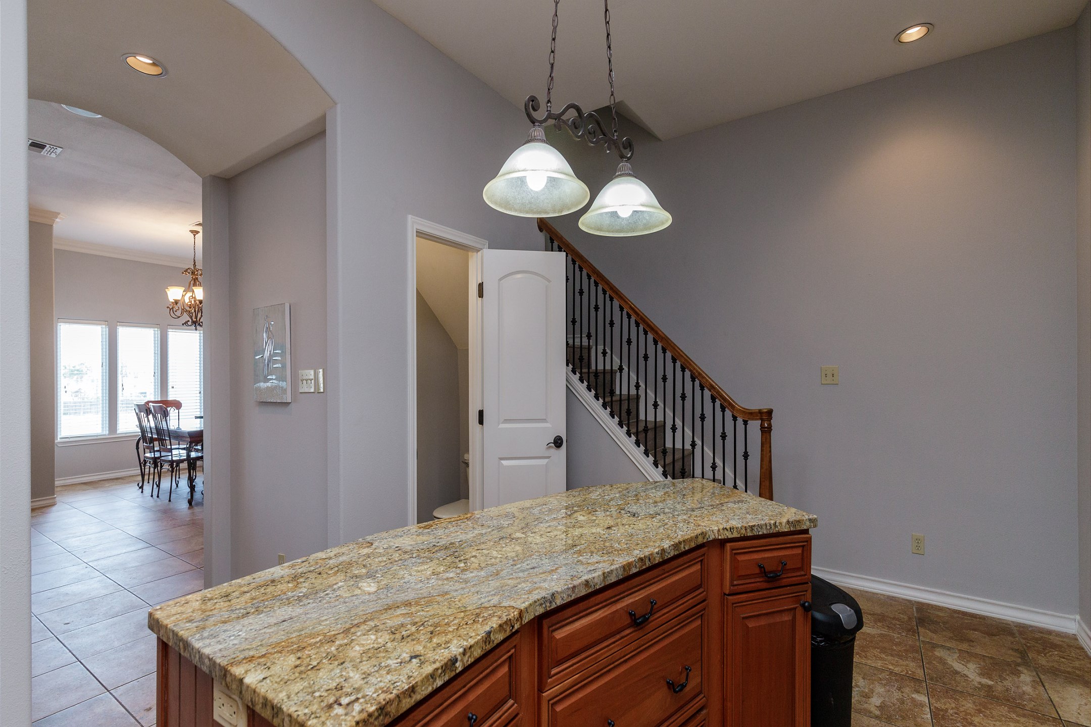 Open concept kitchen with large Island and stairs leading to three bedrooms