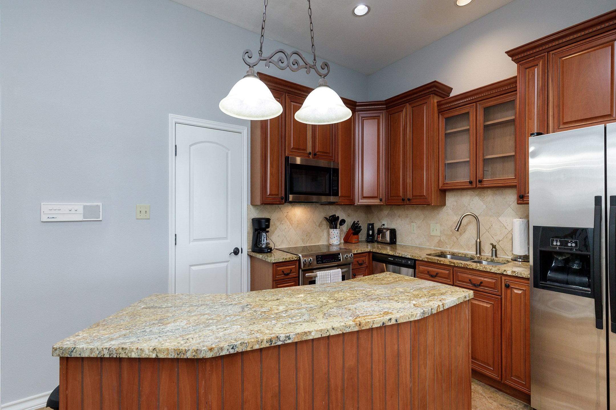 Fully equipped kitchen with stainless steel appliances and ample storage space