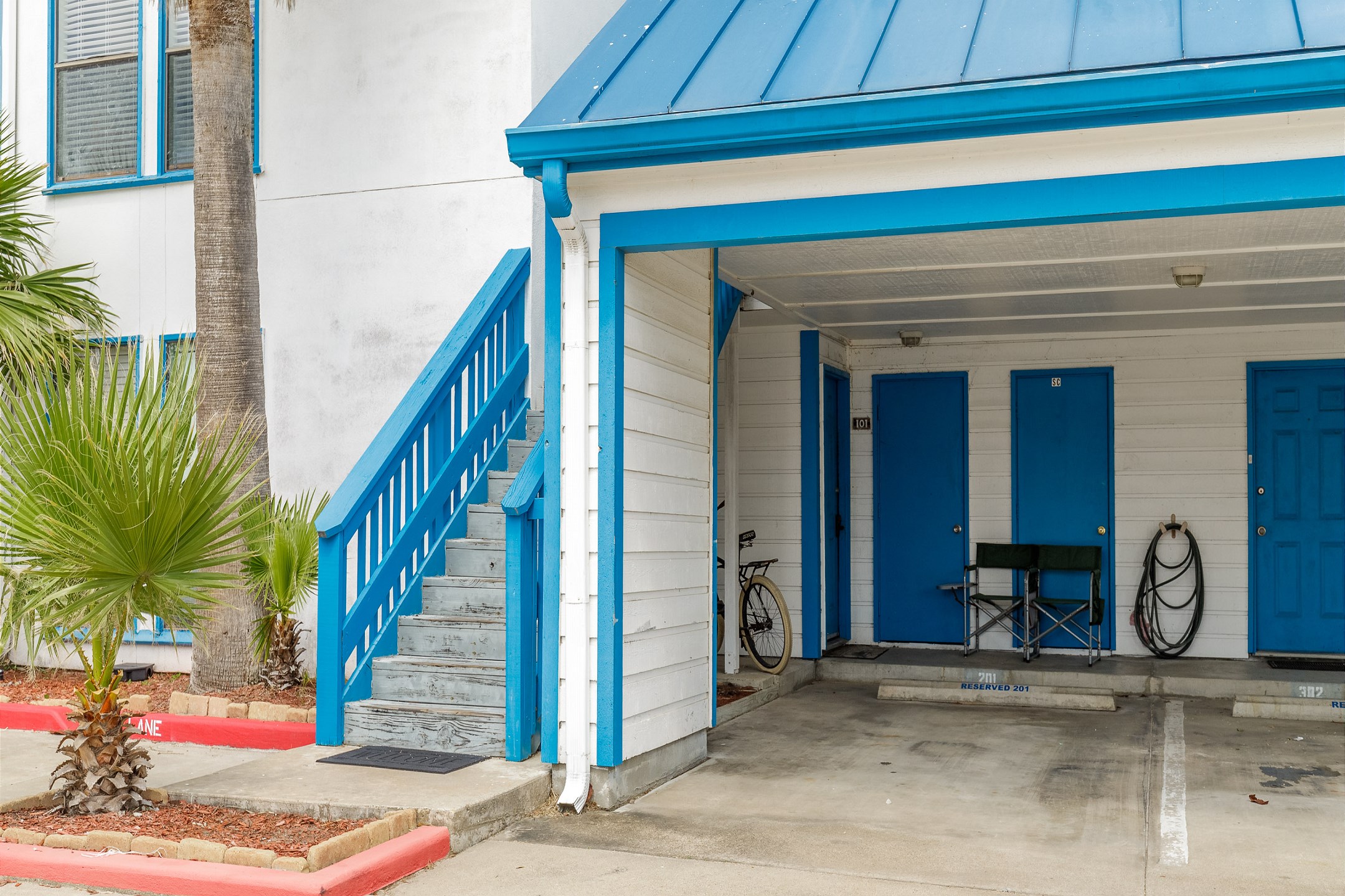 One reserved parking space labeled #201 with open parking for guests 