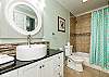 Master bathroom with ample storage space, tub and shower 