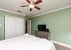 Guest bedroom with king size bed and flat screen TV
