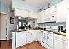 Fully equipped kitchen with ample storage and 12-cup coffee maker 