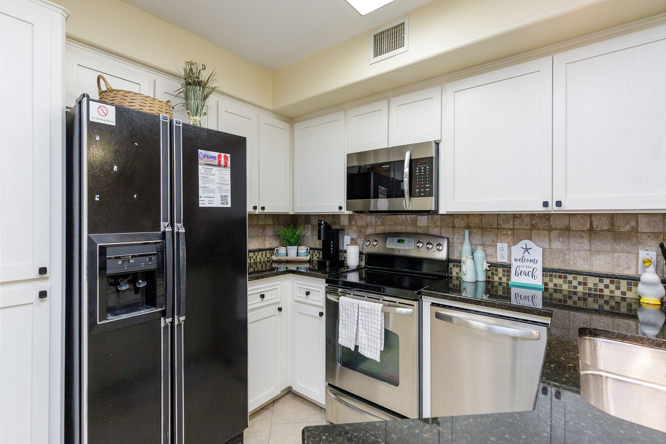 Large kitchen area with stainless steel appliances and upgraded features