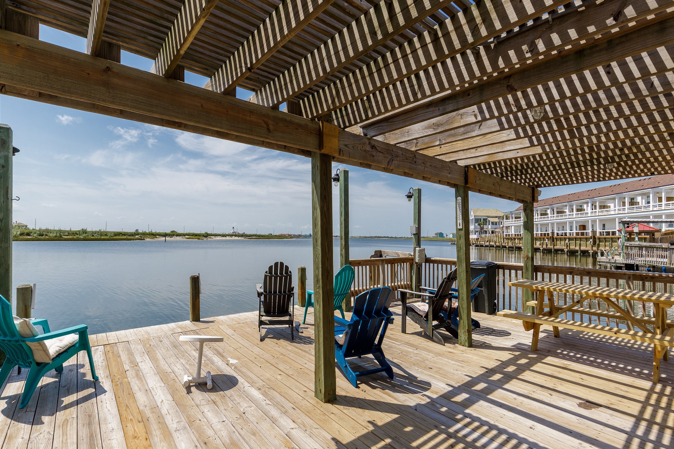 Community deck with waterfront views to unwind on your vacation