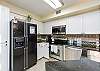 Large kitchen area with stainless steel appliances and upgraded features