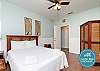 Third bedroom on the first floor with queen size bed, two twin rollaways, private bathroom and private patio 
