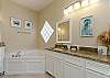 Master bathroom with ample storage, garden tub, and walk in shower 