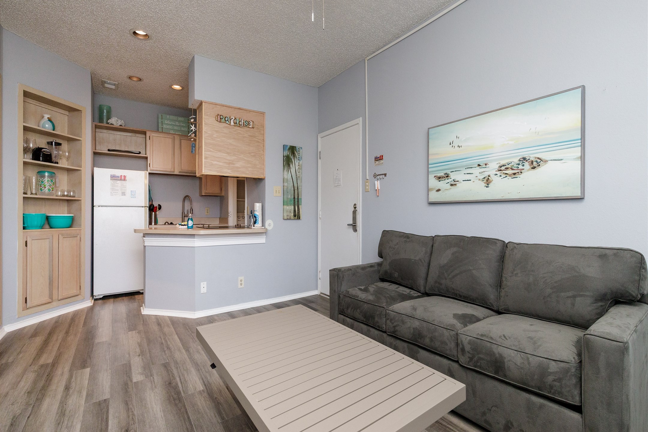 Living area with queen size sleeper sofa and coffee table that pulls up into the dining table
