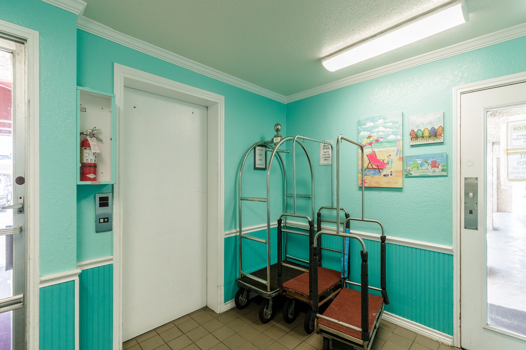 First floor area with luggage carts and an elevator 