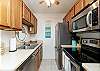 Fully equipped kitchen with stainless steel appliances and ample counter space 