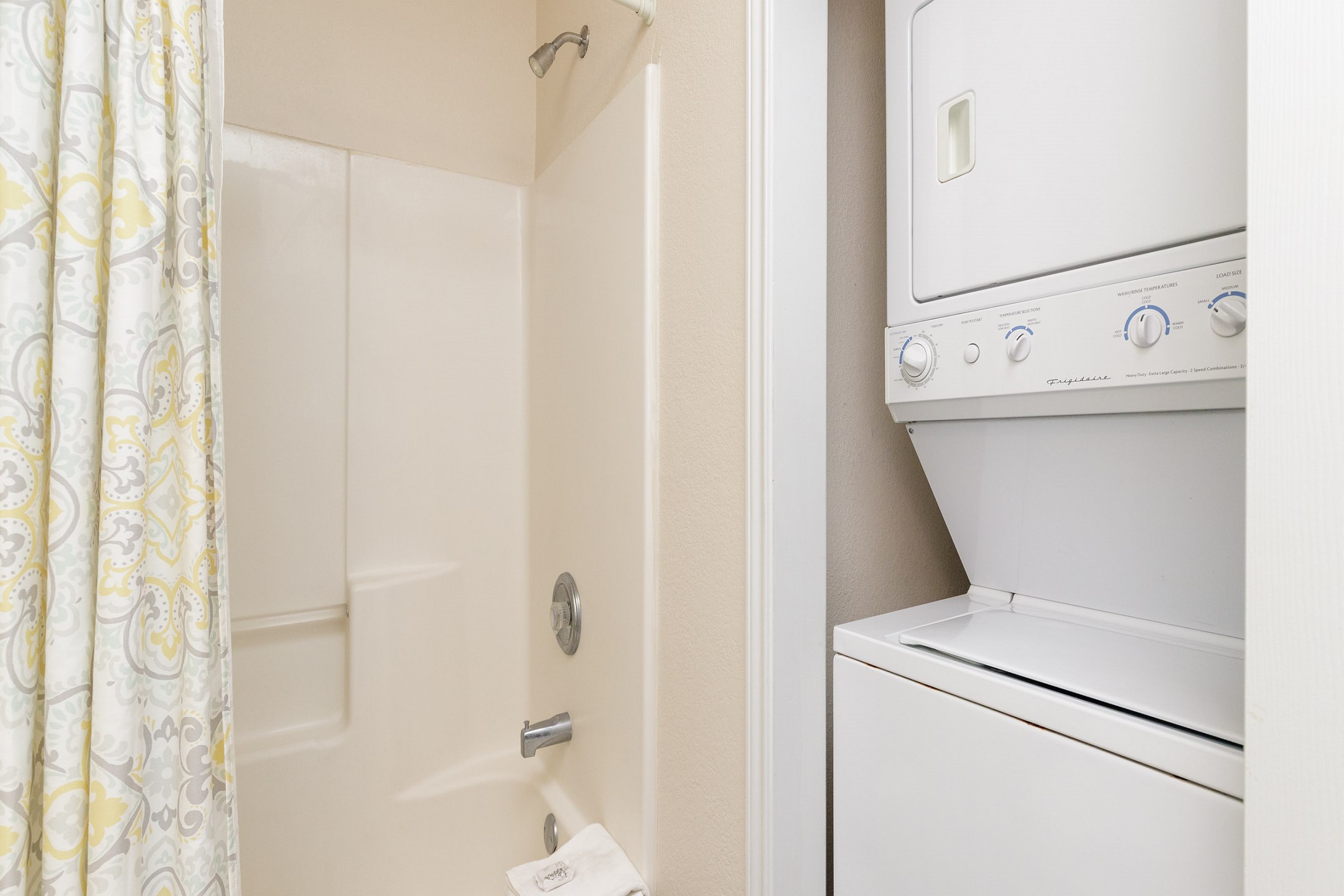 Washer and dryer located in guest bathroom 