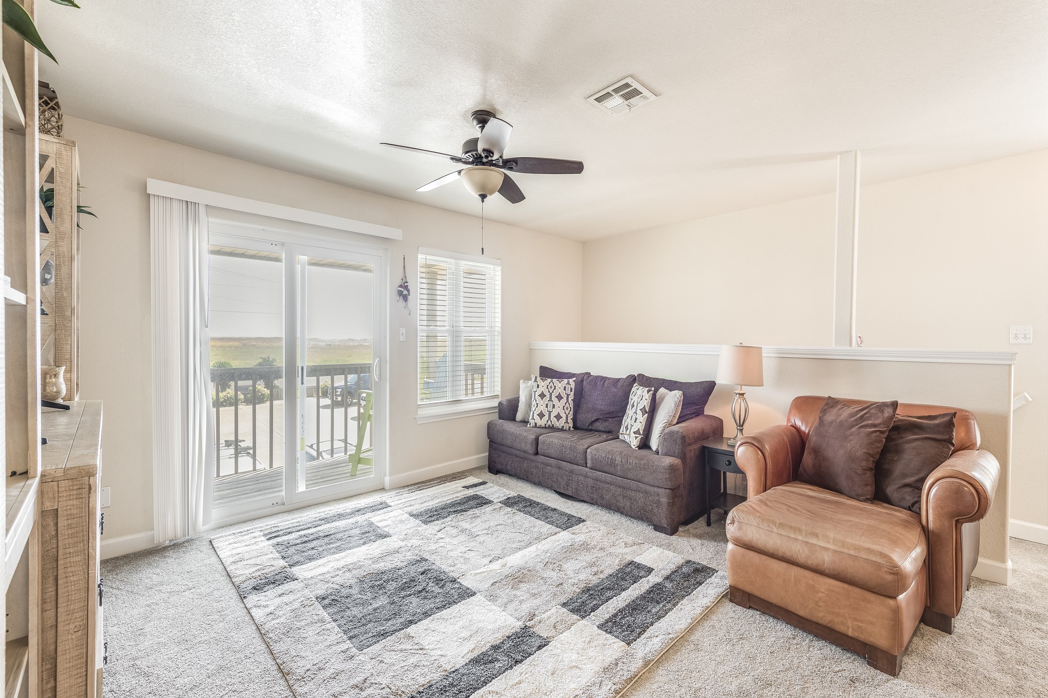 Relax in the modern living room equipped with cozy seating and sleek flat-screen TV