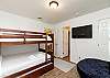 Third bedroom with full over full size bunk bed and twin trundle, along with flat screen TV