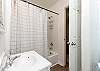Guest bathroom with tub and shower 