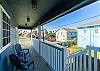 Master balcony with cozy chairs, leading to the backyard