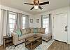Newly updated living space with comfy sectional and large windows 