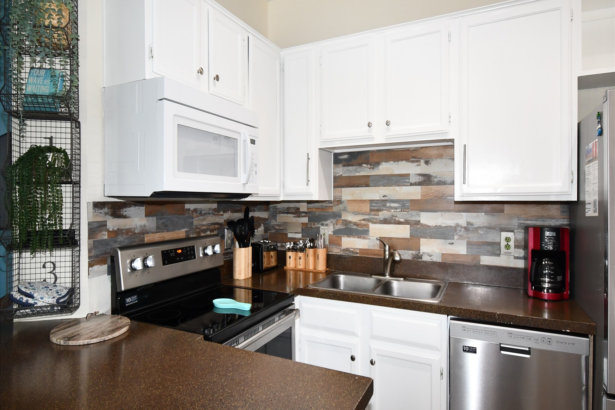 Coffee maker, toaster, cookware, dinnerware, and other kitchen essentials provided