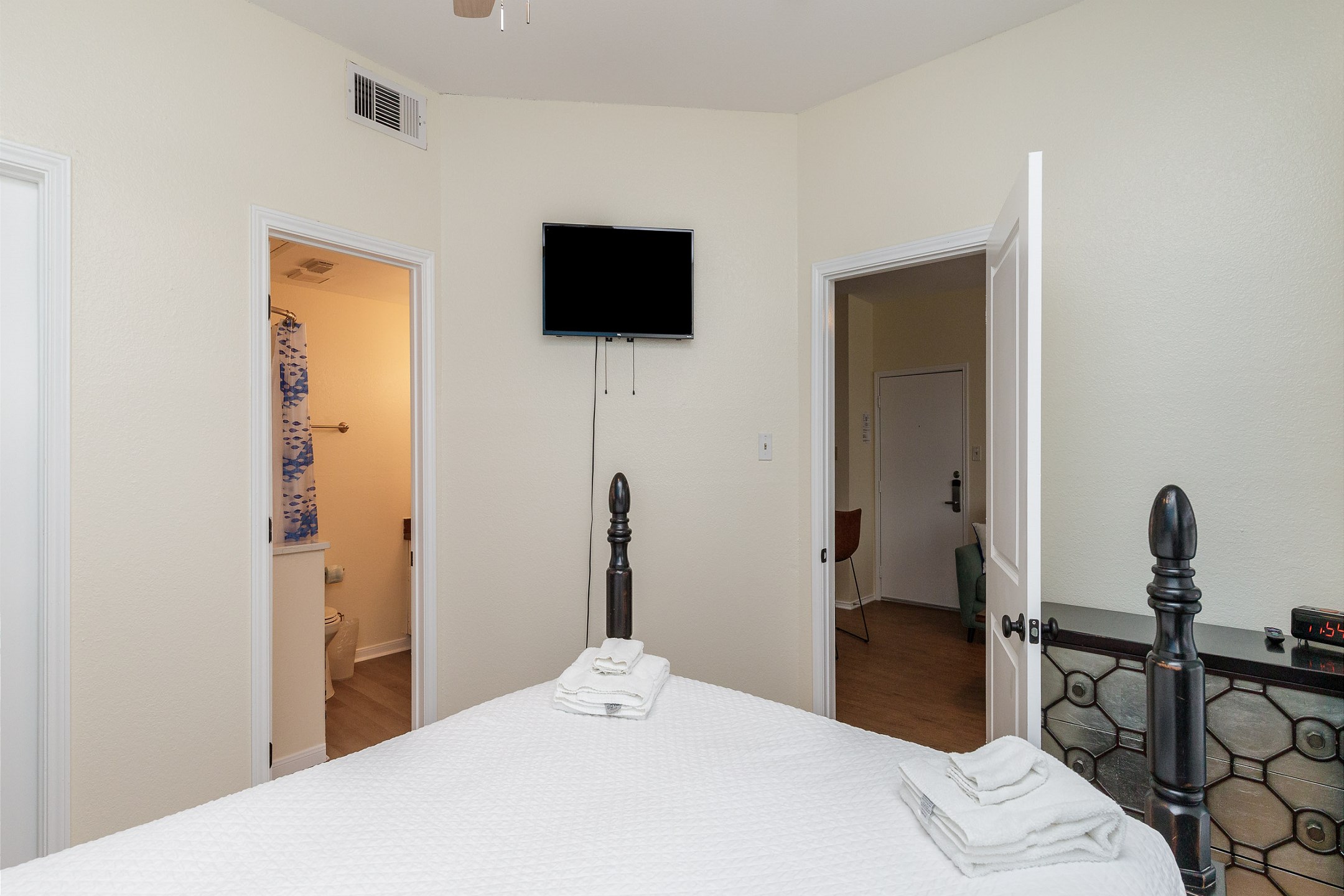 Master bedroom with queen size bed, private bathroom, and flat screen TV