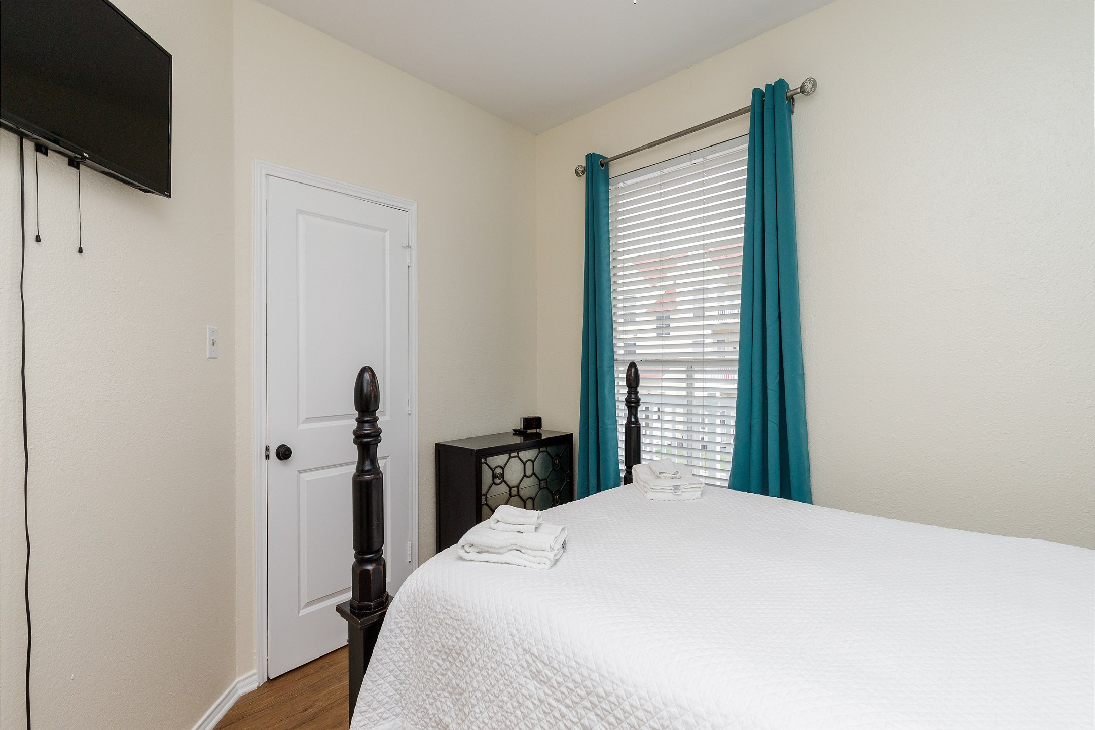 Master bedroom with queen size bed, private bathroom, and flat screen TV