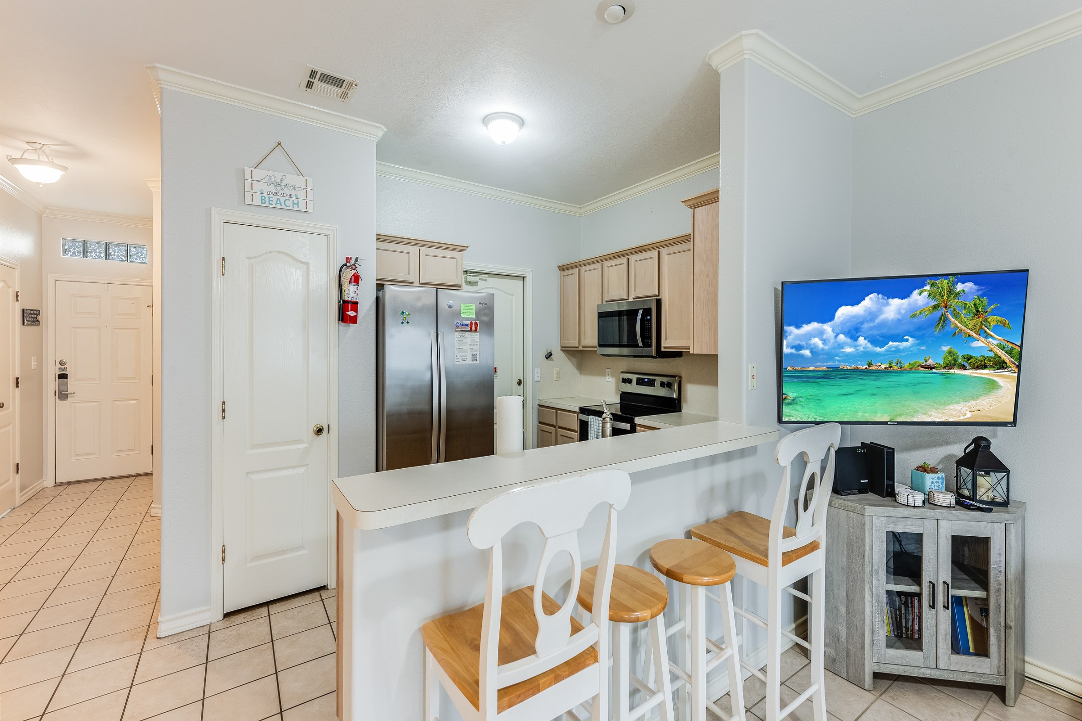Breakfast bar seating for four with a view of the flat screen TV