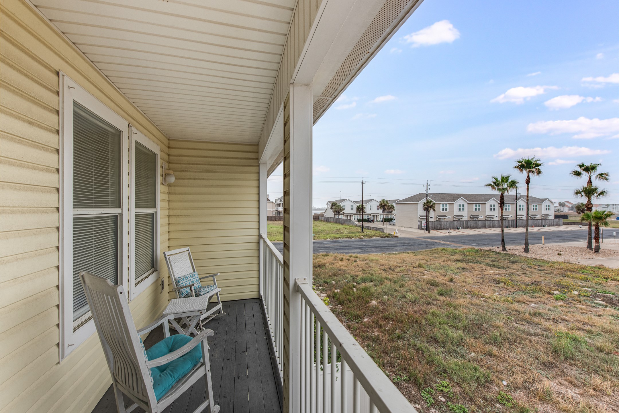 Private balcony off the loft area with rocking chairs and table