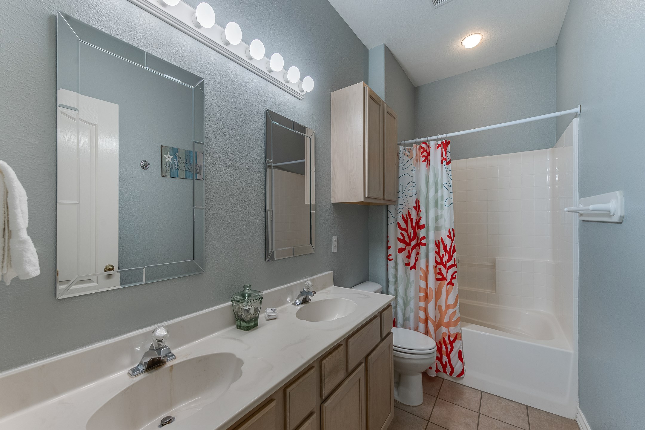 Private bathroom off the master bedroom with double sinks and tub/shower combo
