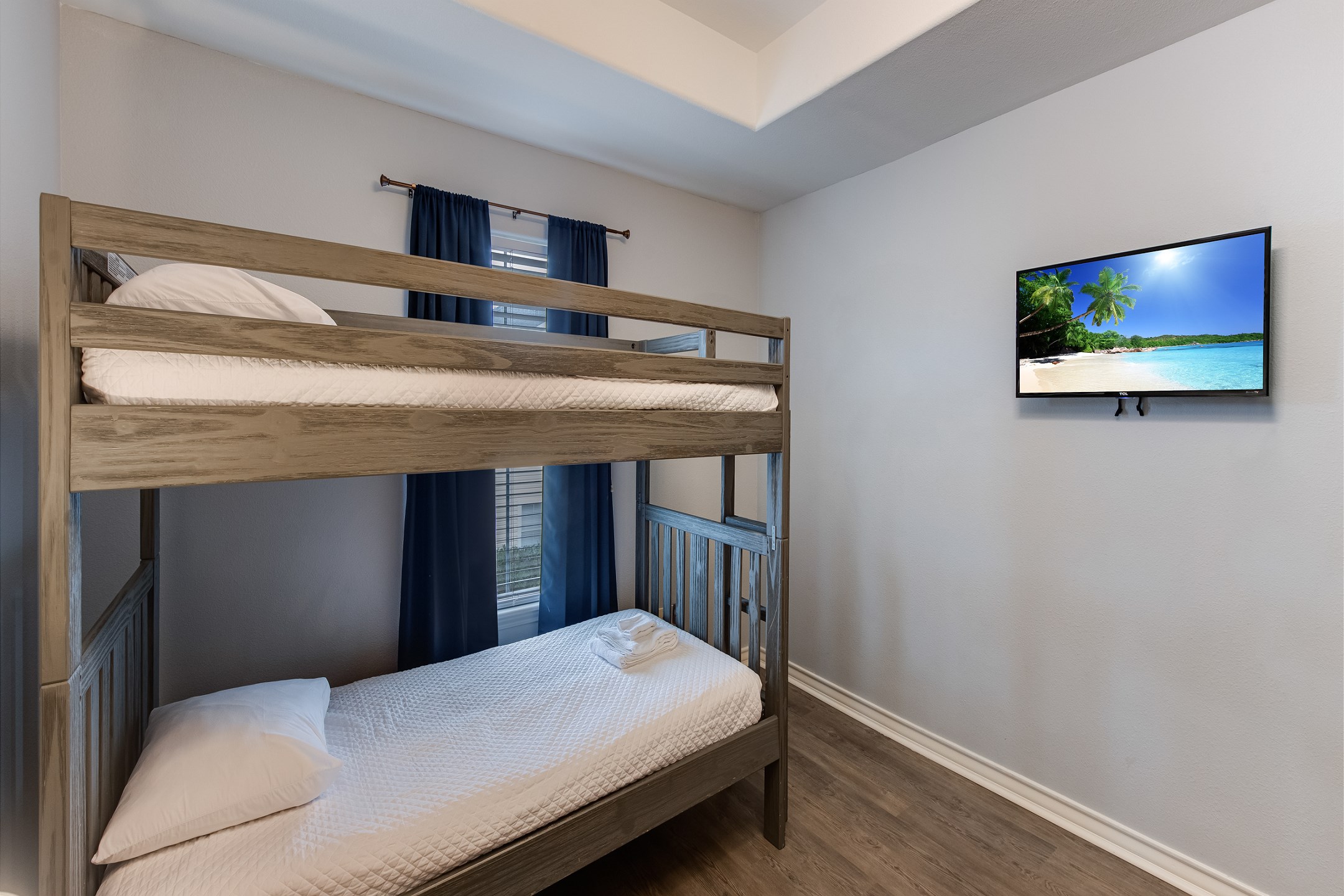 Third bedroom on the second floor with two sets of twin size bunk beds and flat screen TV
