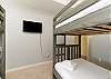 Third bedroom on the second floor with two sets of twin size bunk beds and flat screen TV
