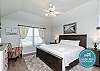 Master bedroom with king size bed, private bathroom, and flat screen TV