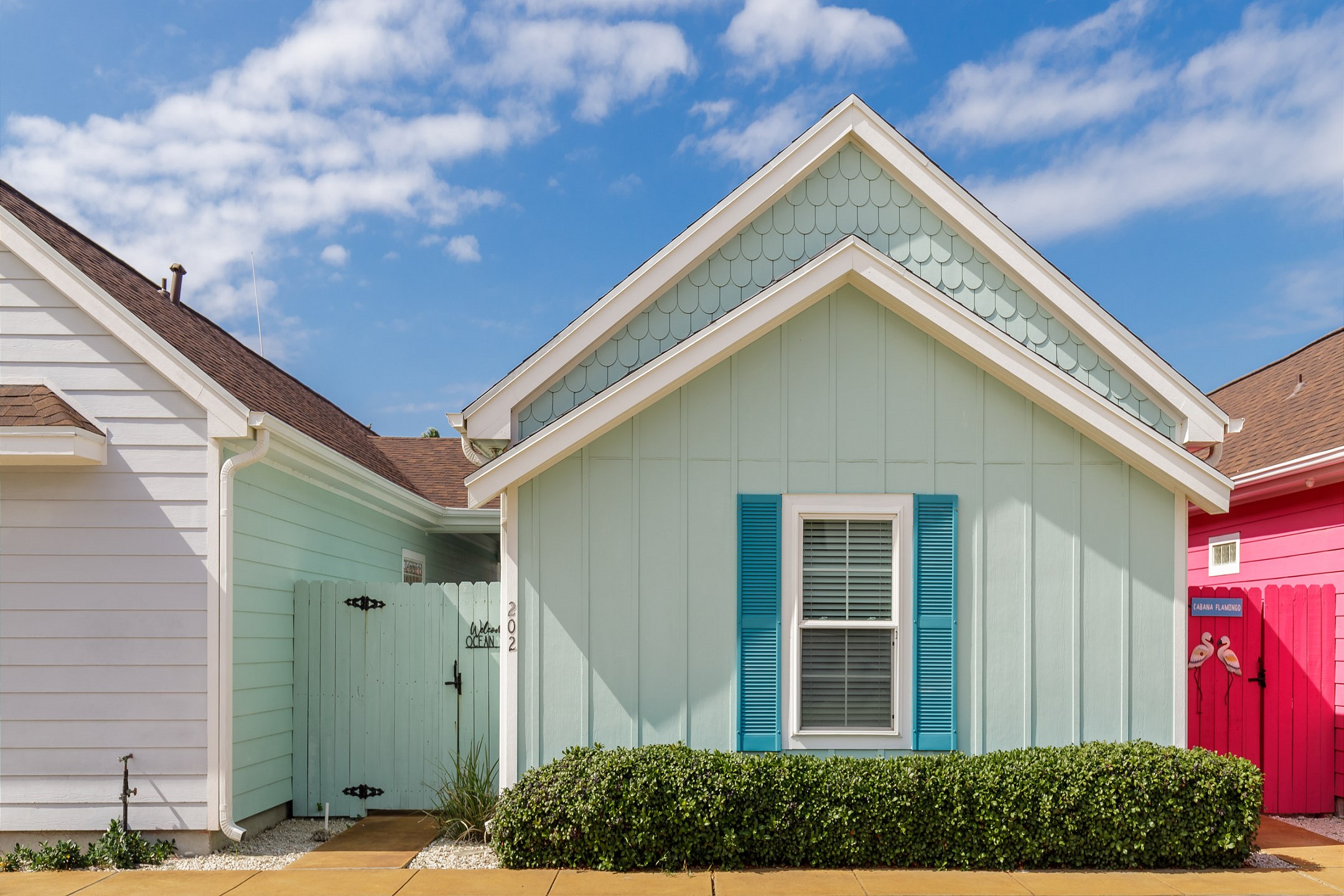 Front view of property with a latched gate for entrance - making the private patio space more enjoyable